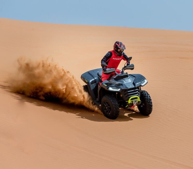 A rider throwing sand on a Segway Snarler AT5