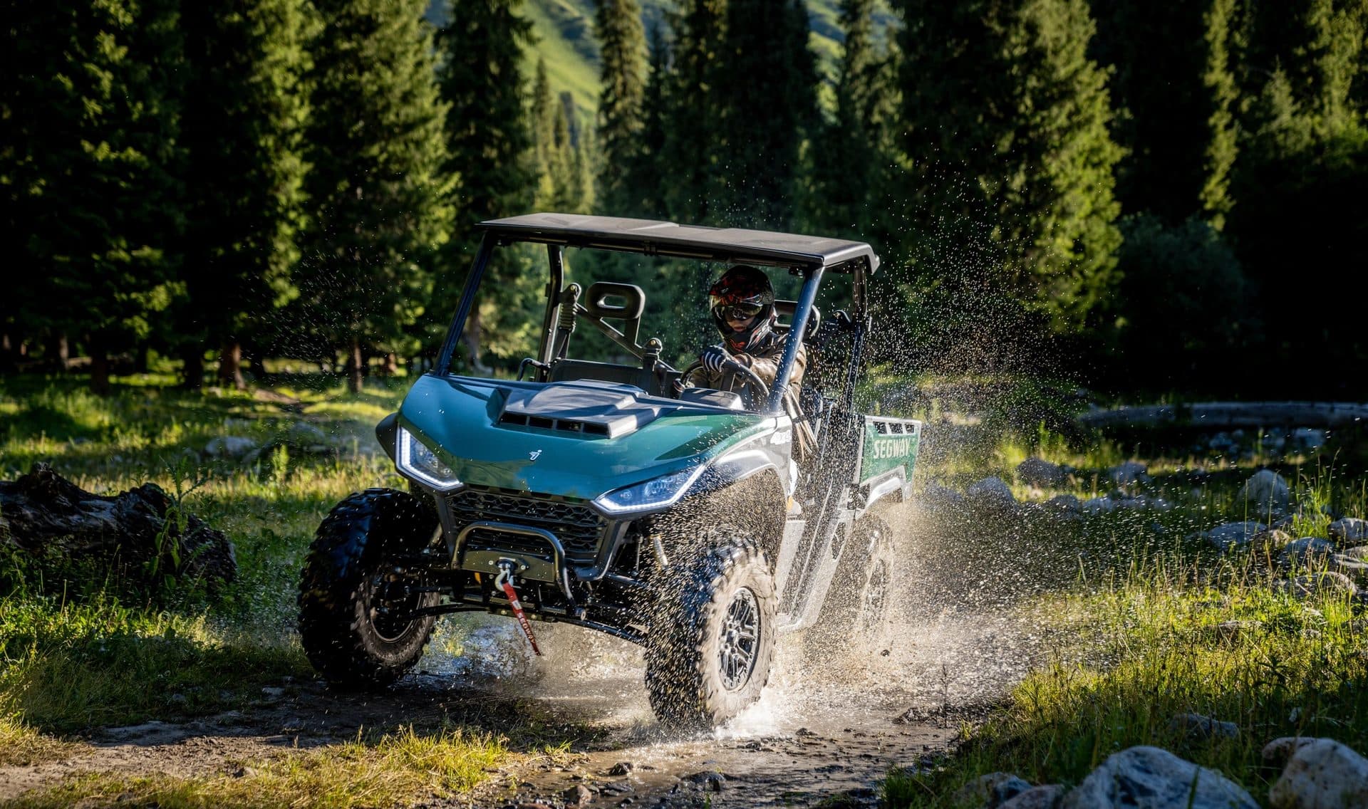 Segway Fugleman UT6 splashing through a forest stream